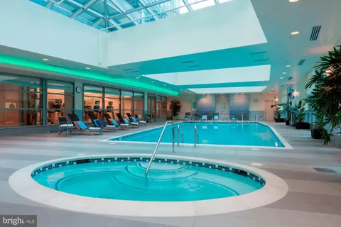 an outdoor space with swimming pool and furniture