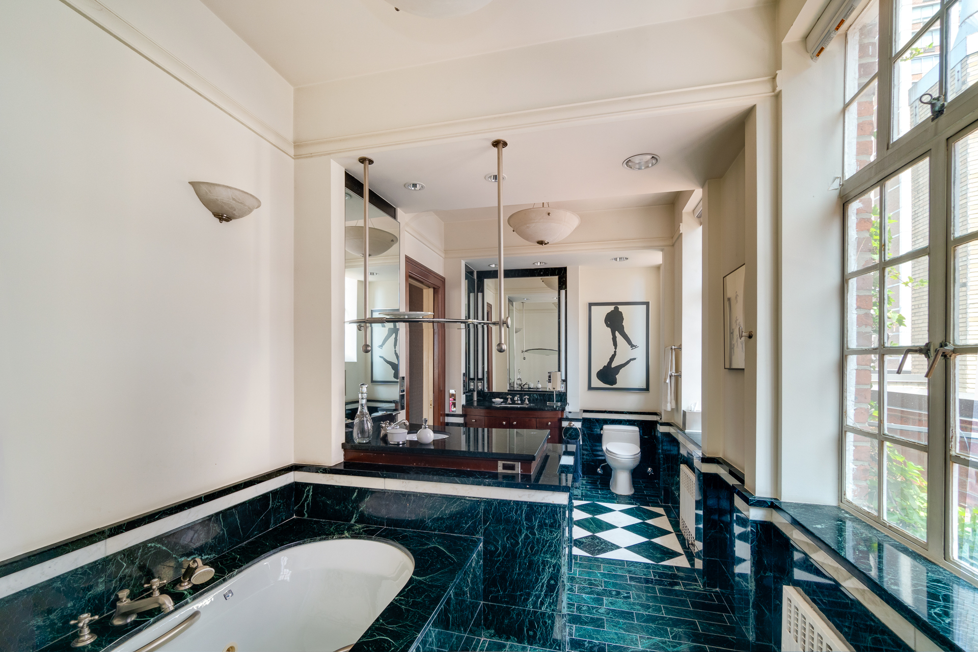 340 East 72nd Street, Unit PH Manhattan, NY 10021 - Photo 7 of 12 a bathroom with a sink a large mirror and a shower