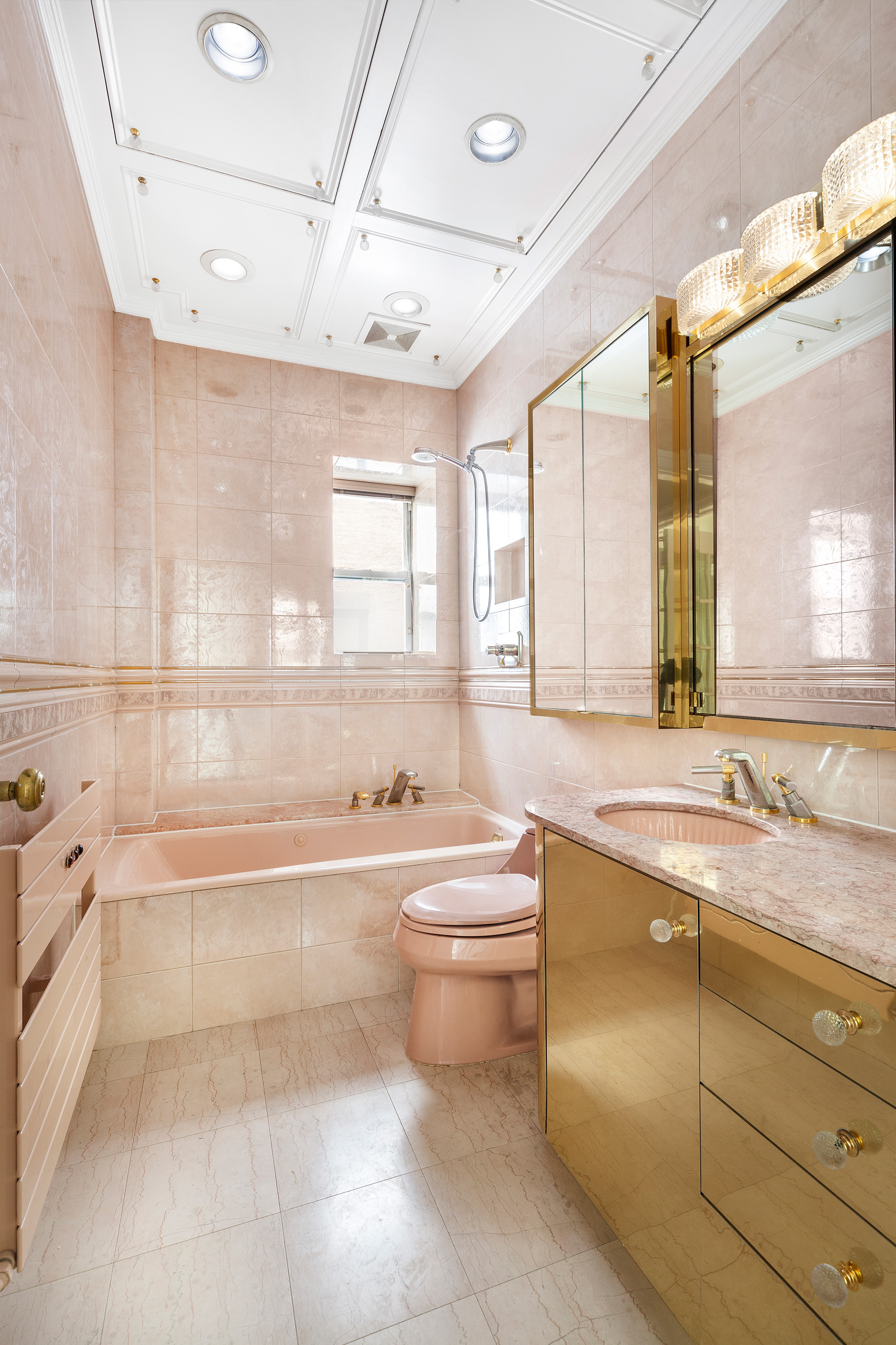 34 East 64th Street, Unit 2 Manhattan, NY 10065 - Photo 7 of 7 a bathroom with a granite countertop toilet a sink and bathtub
