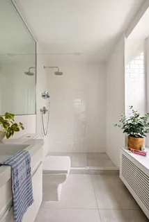 a bathroom with a granite countertop sink a toilet and shower