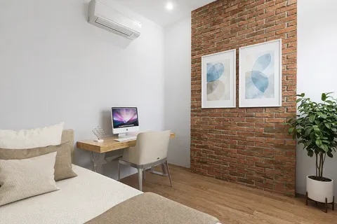 a living room with furniture and a potted plant