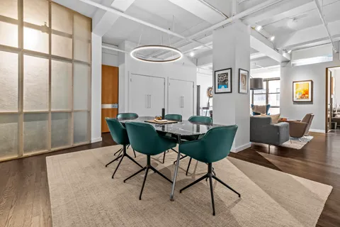 a view of a dining room with furniture and a large window