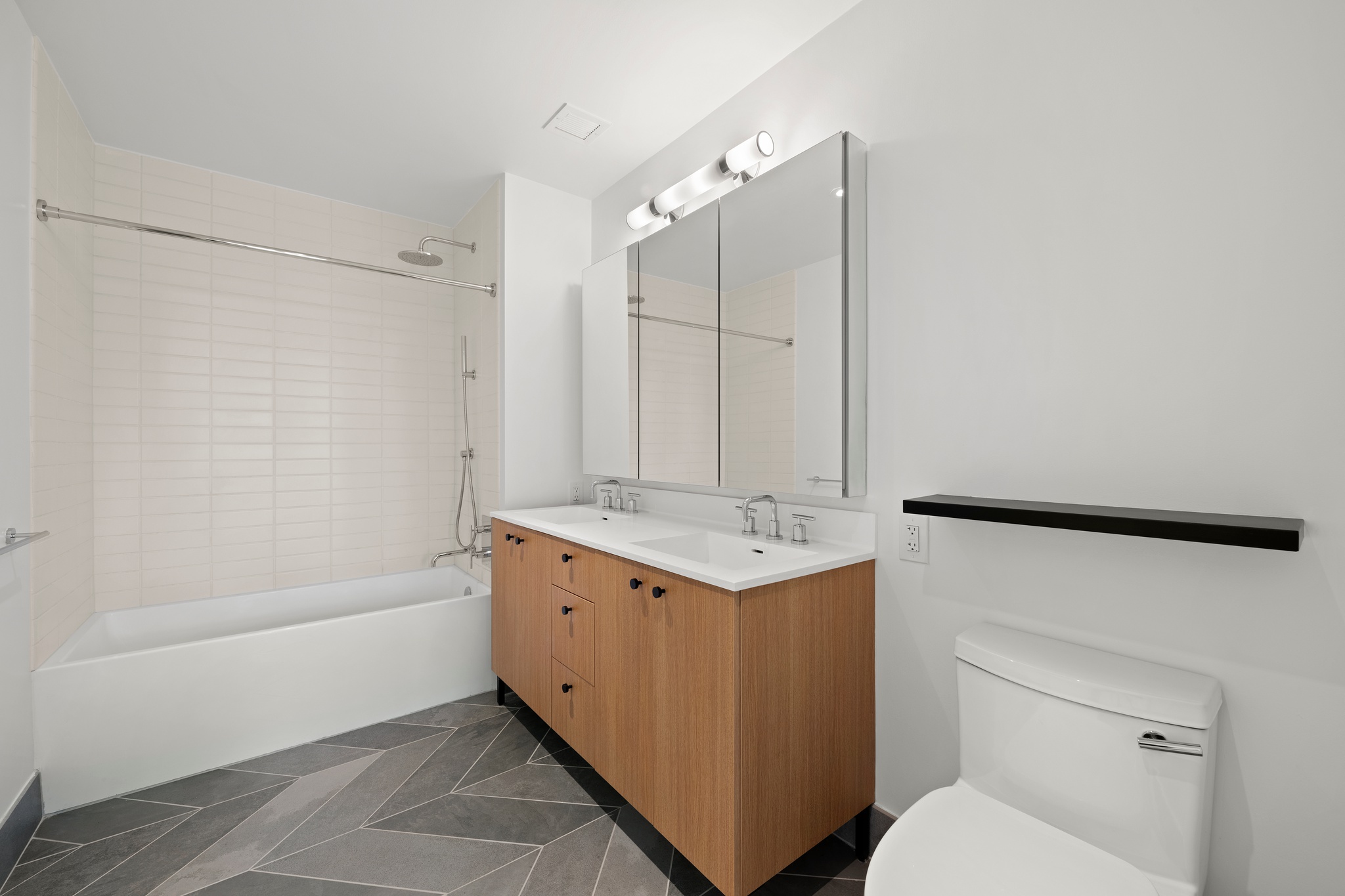 160 Front Street, Unit 706 Brooklyn, NY 11201 - Photo 8 of 17 a bathroom with a granite countertop sink toilet and shower