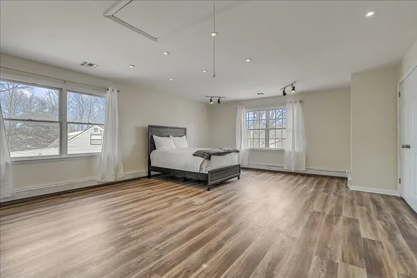 a living room with a hard wood floor and window