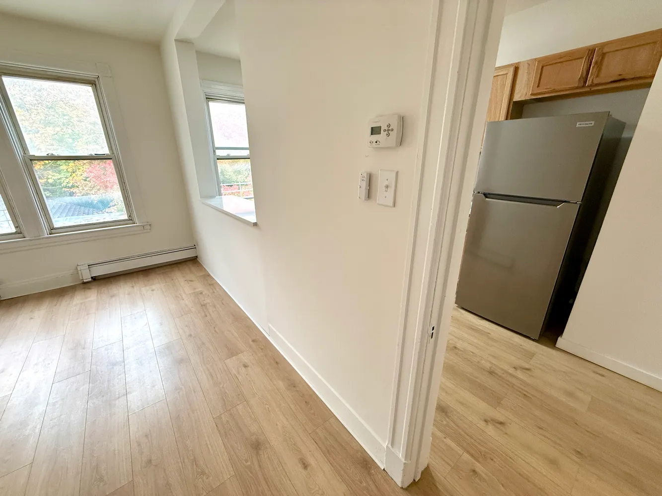 a view of hallway with wooden floor and staircase