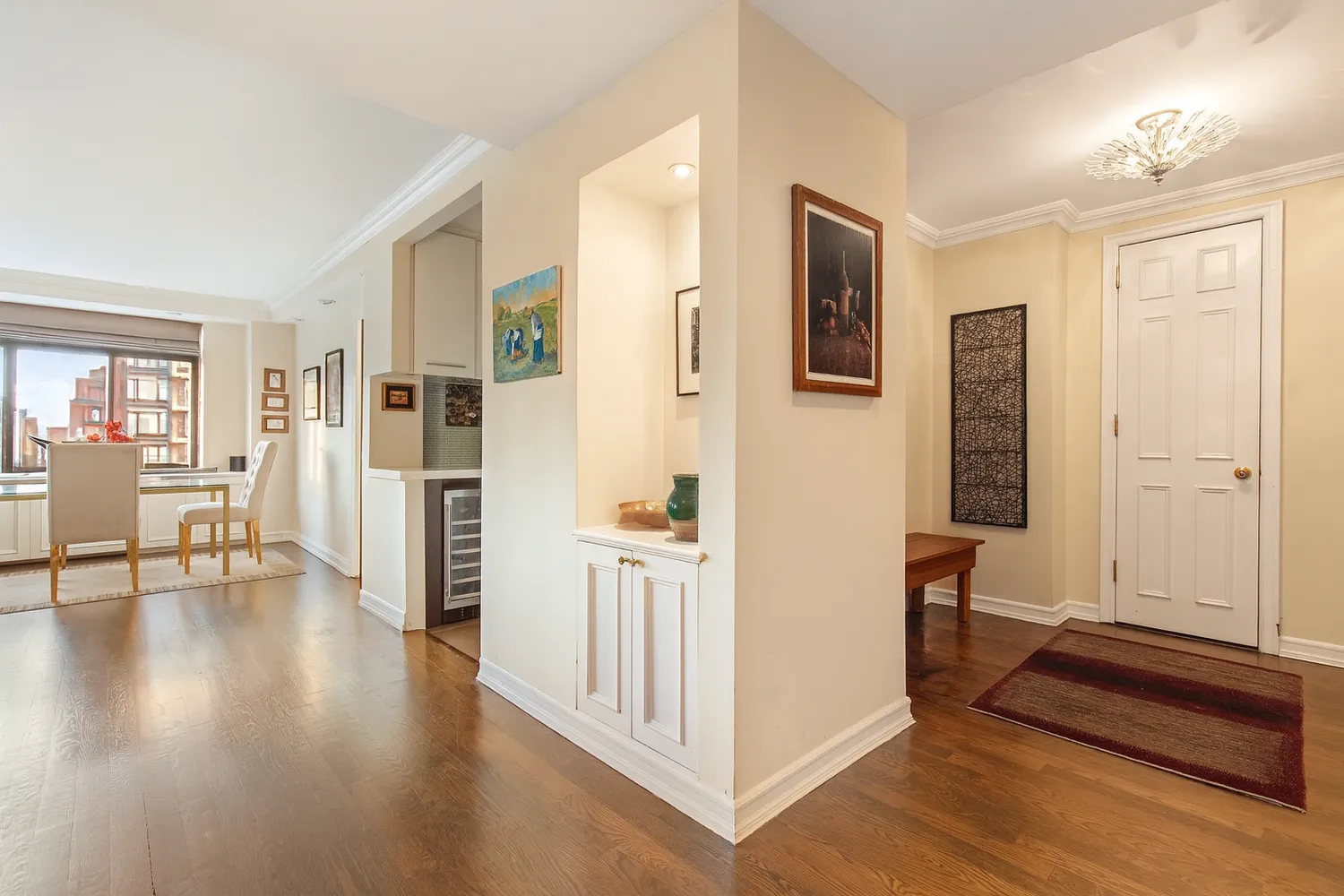 a view of a livingroom with wooden floor and a flat screen tv