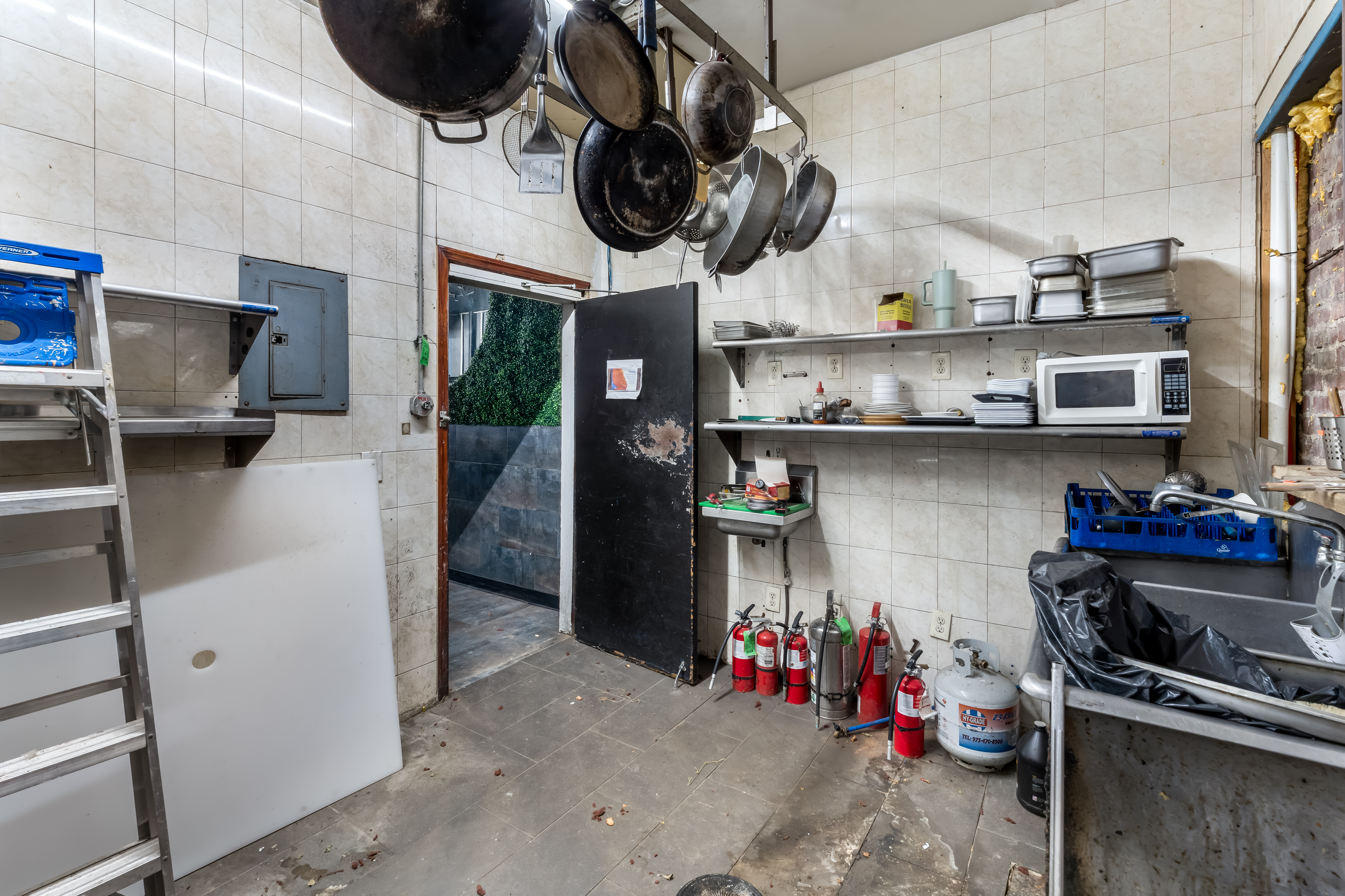 646 Newark Avenue, Unit COMMERCIAL Jersey City, NJ 07306 - Photo 16 of 35 a kitchen with stainless steel appliances granite countertop a sink and a stove