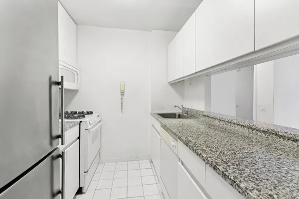 a kitchen with a sink stove and refrigerator