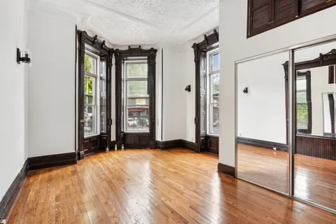 a view of an entryway with wooden floor