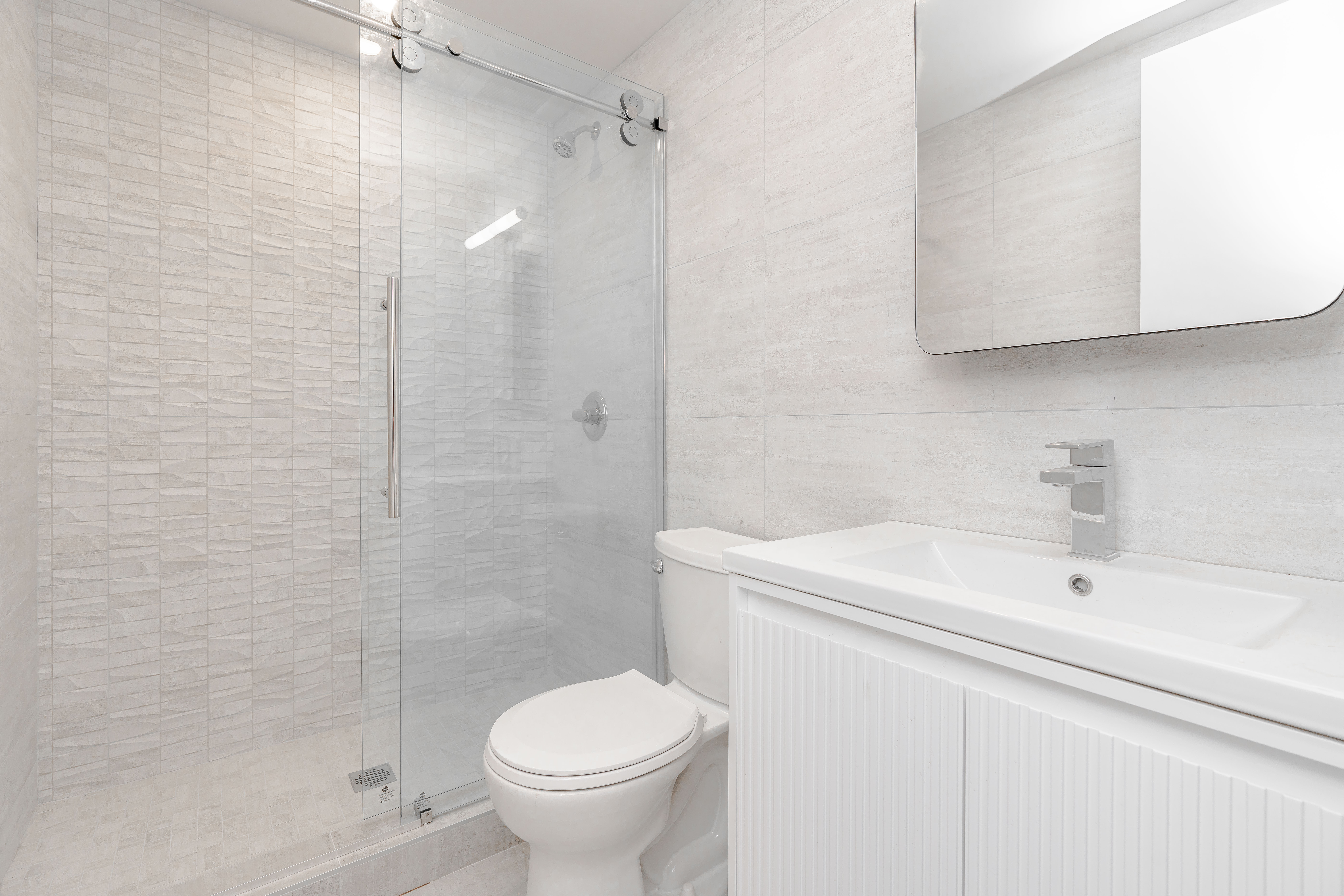 20-15 46th Street, Unit 2 Queens, NY 11105 - Photo 6 of 16 a bathroom with a sink toilet and shower