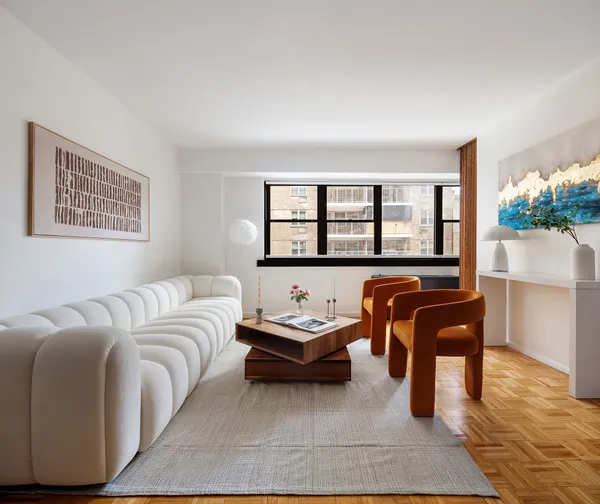 a living room with furniture and a large window