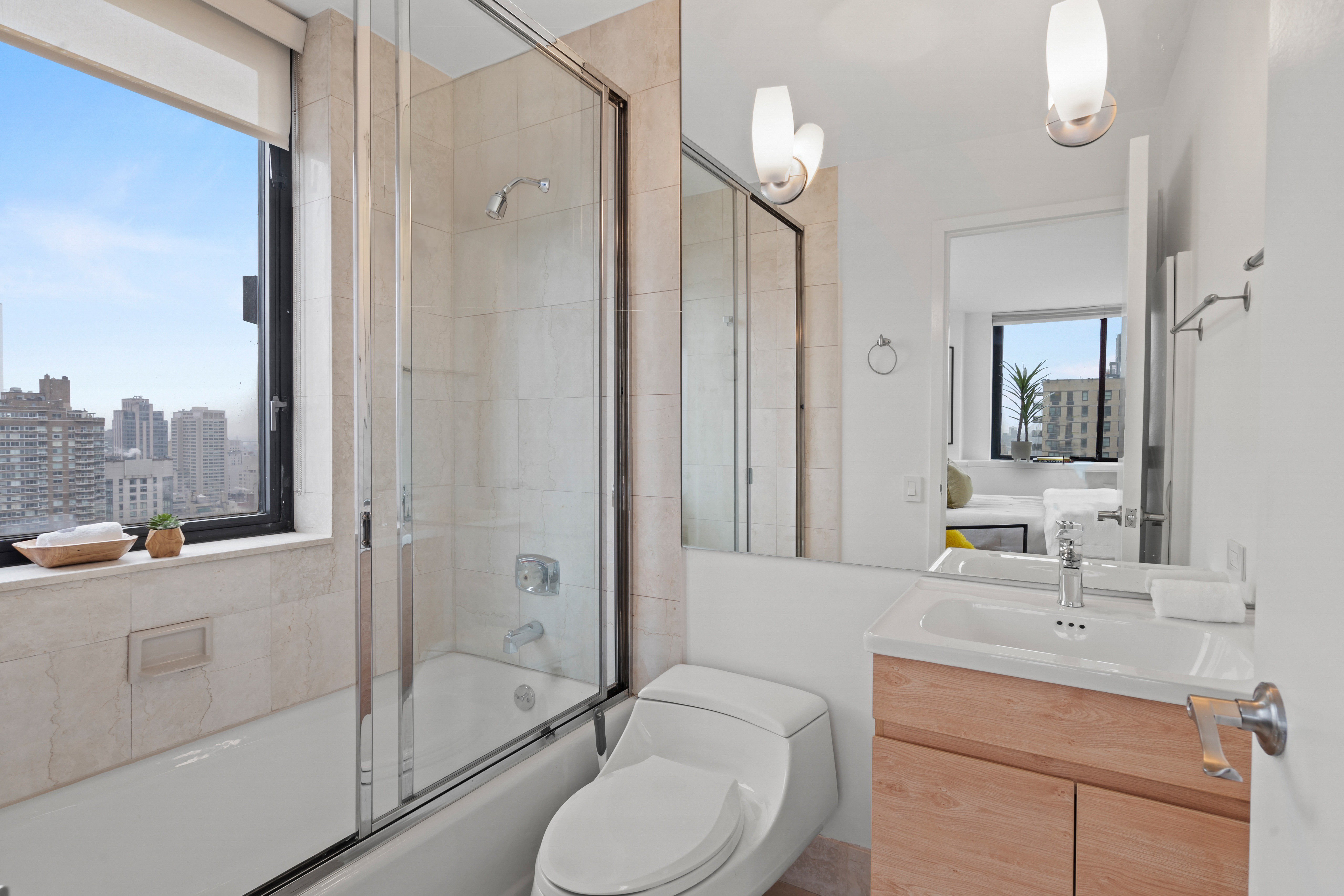 330 East 75th Street, Unit 32A Manhattan, NY 10021 - Photo 11 of 17 a bathroom with a sink a toilet and shower