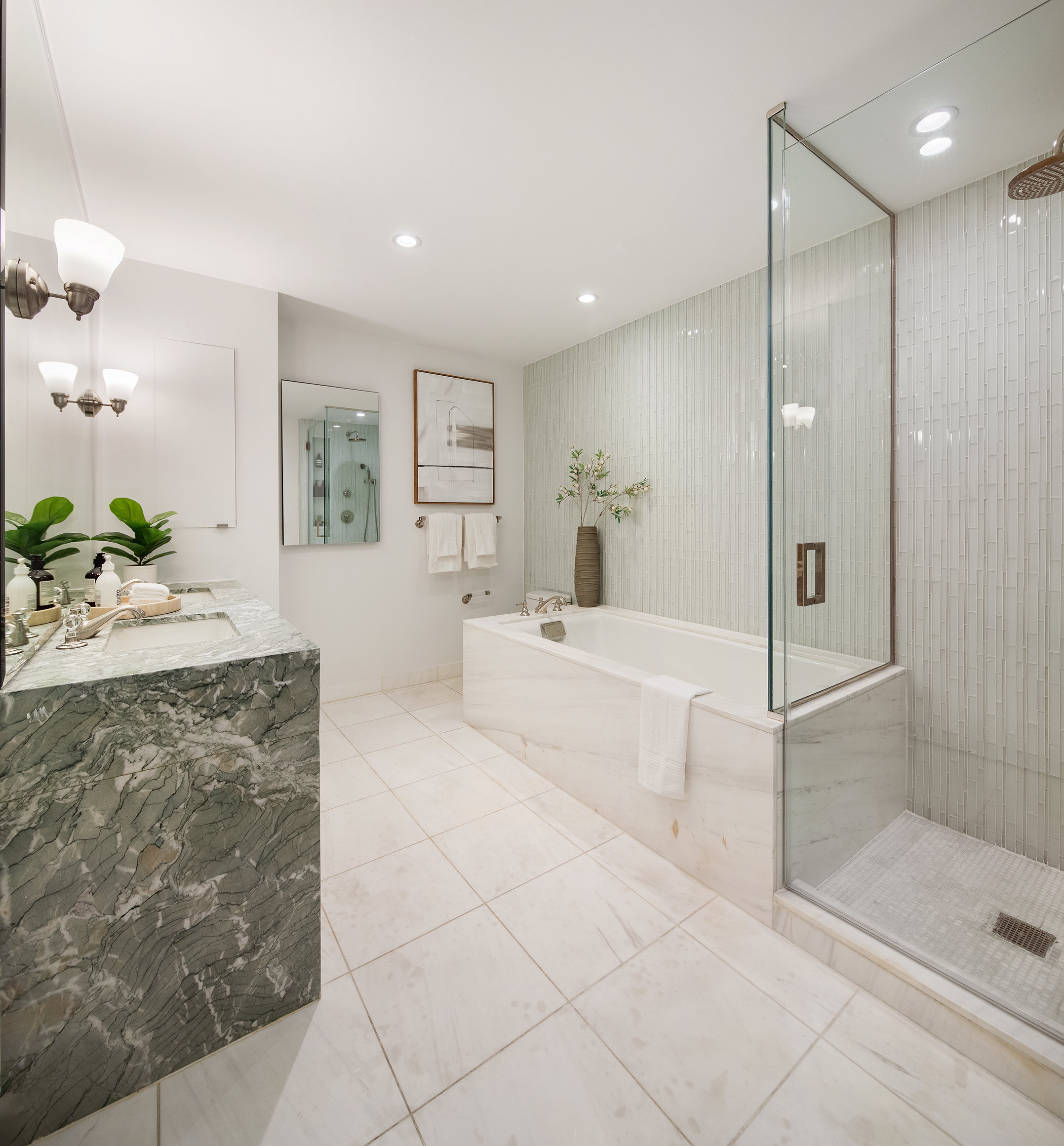 305 East 85th Street, Unit 5B Manhattan, NY 10028 - Photo 8 of 11 a spacious bathroom with a double vanity sink mirror and shower
