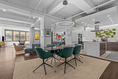 a living room with lots of furniture and kitchen view