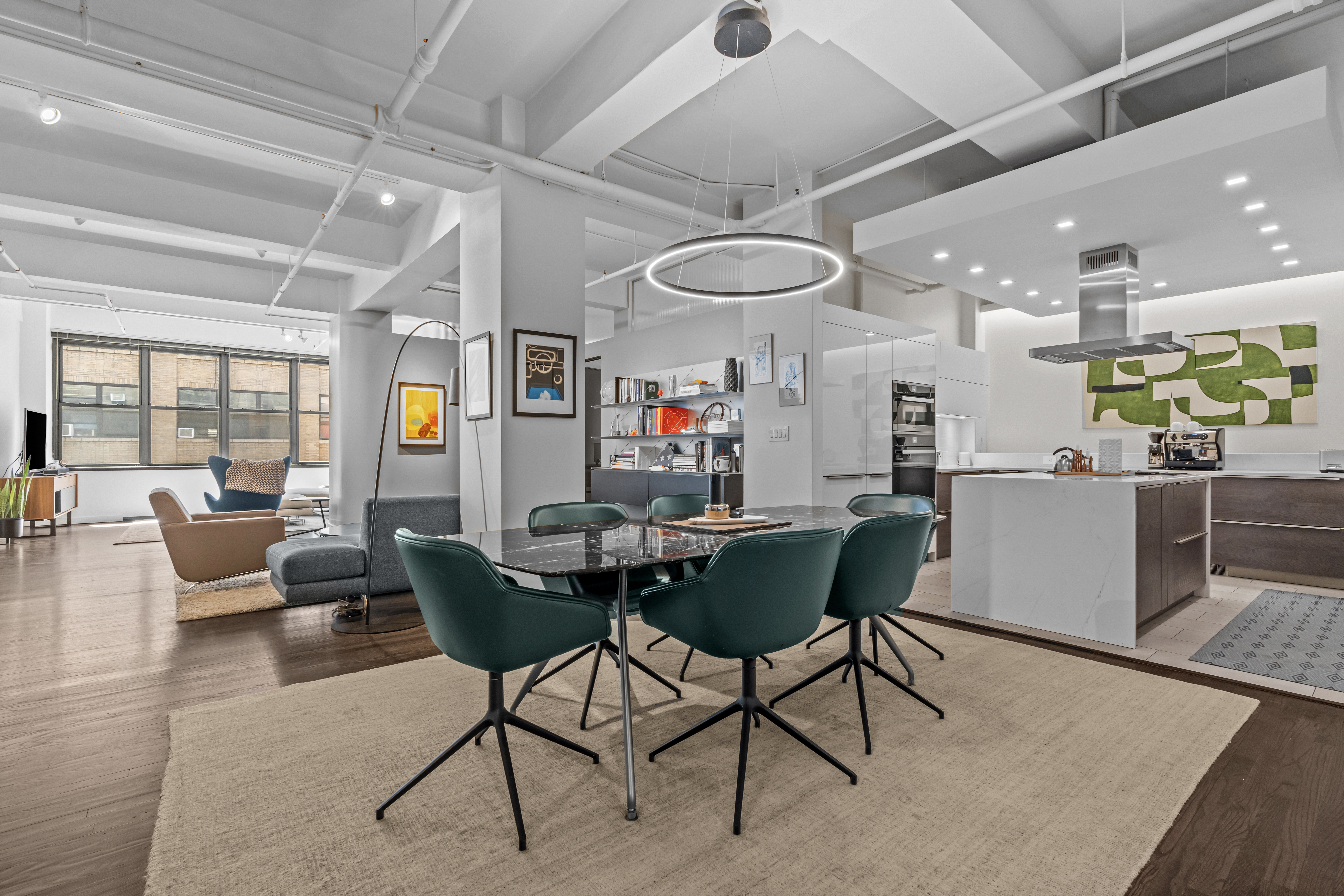 a living room with lots of furniture and kitchen view
