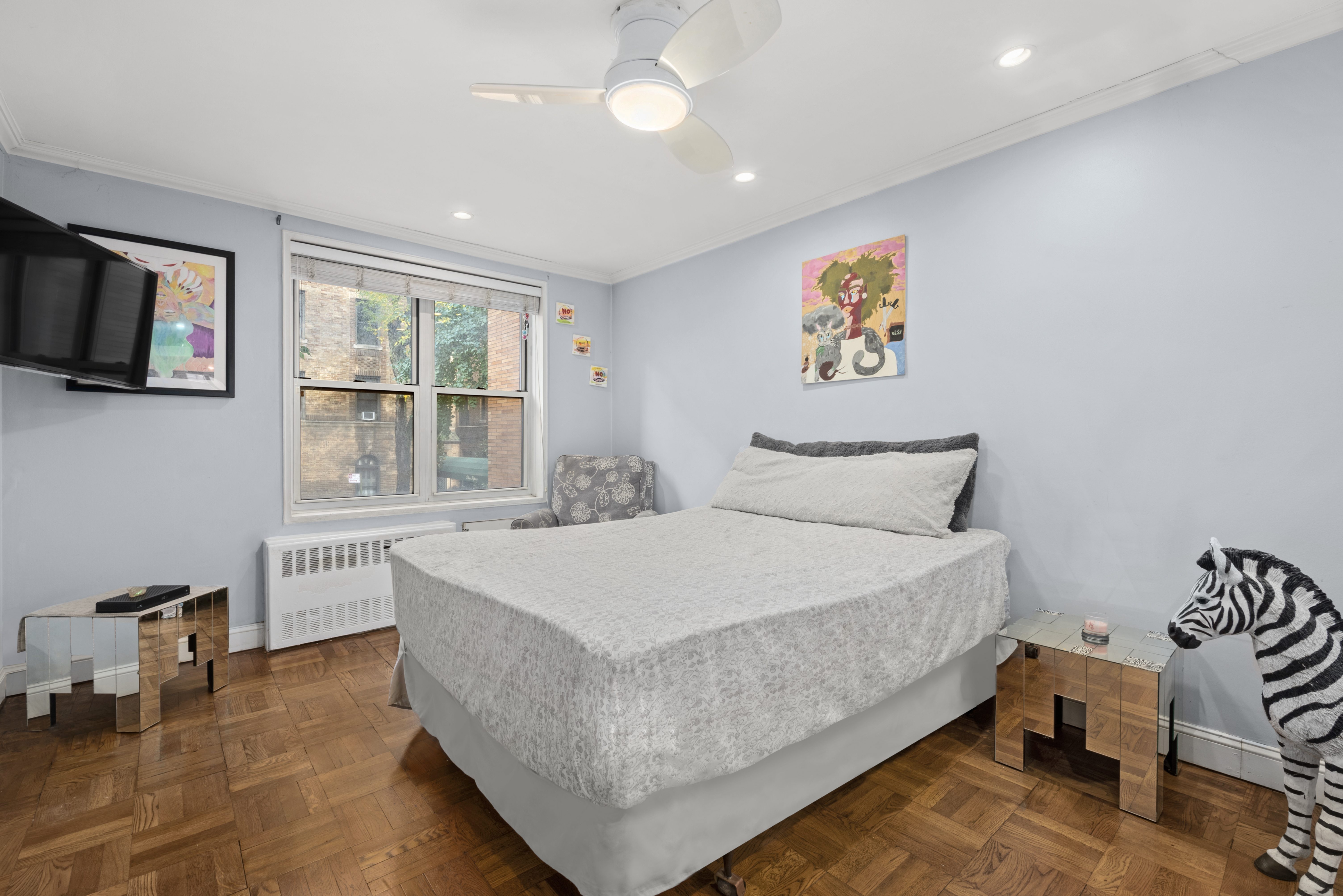 302 East 88th Street, Unit 2G Manhattan, NY 10128 - Photo 13 of 16 a spacious bedroom with a bed and a table in it