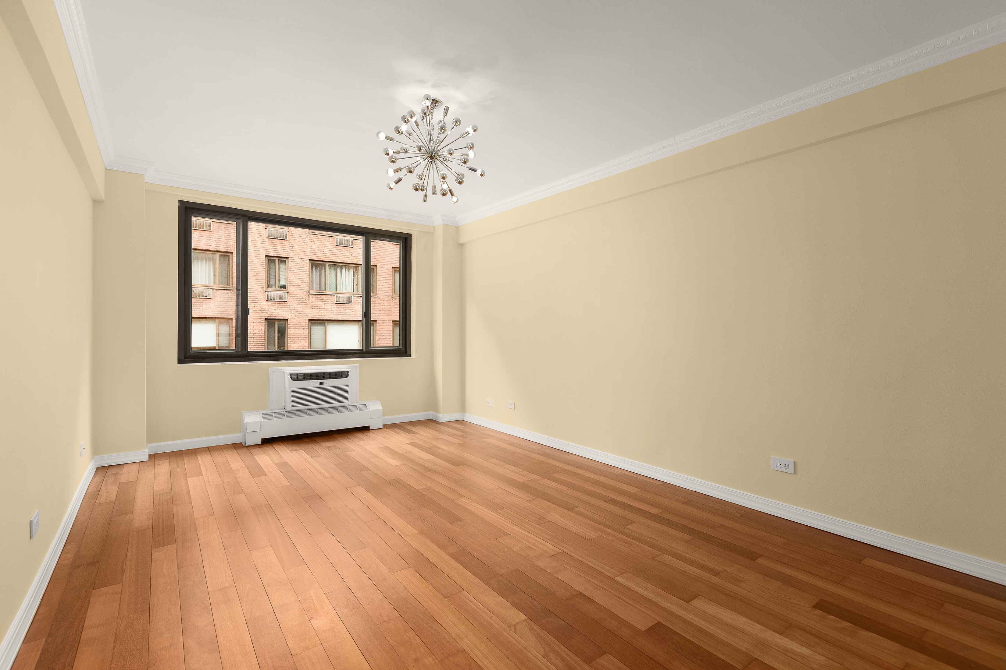 425 East 63rd Street, Unit E7A Manhattan, NY 10065 - Photo 9 of 13 a view of an empty room with a window and wooden floor
