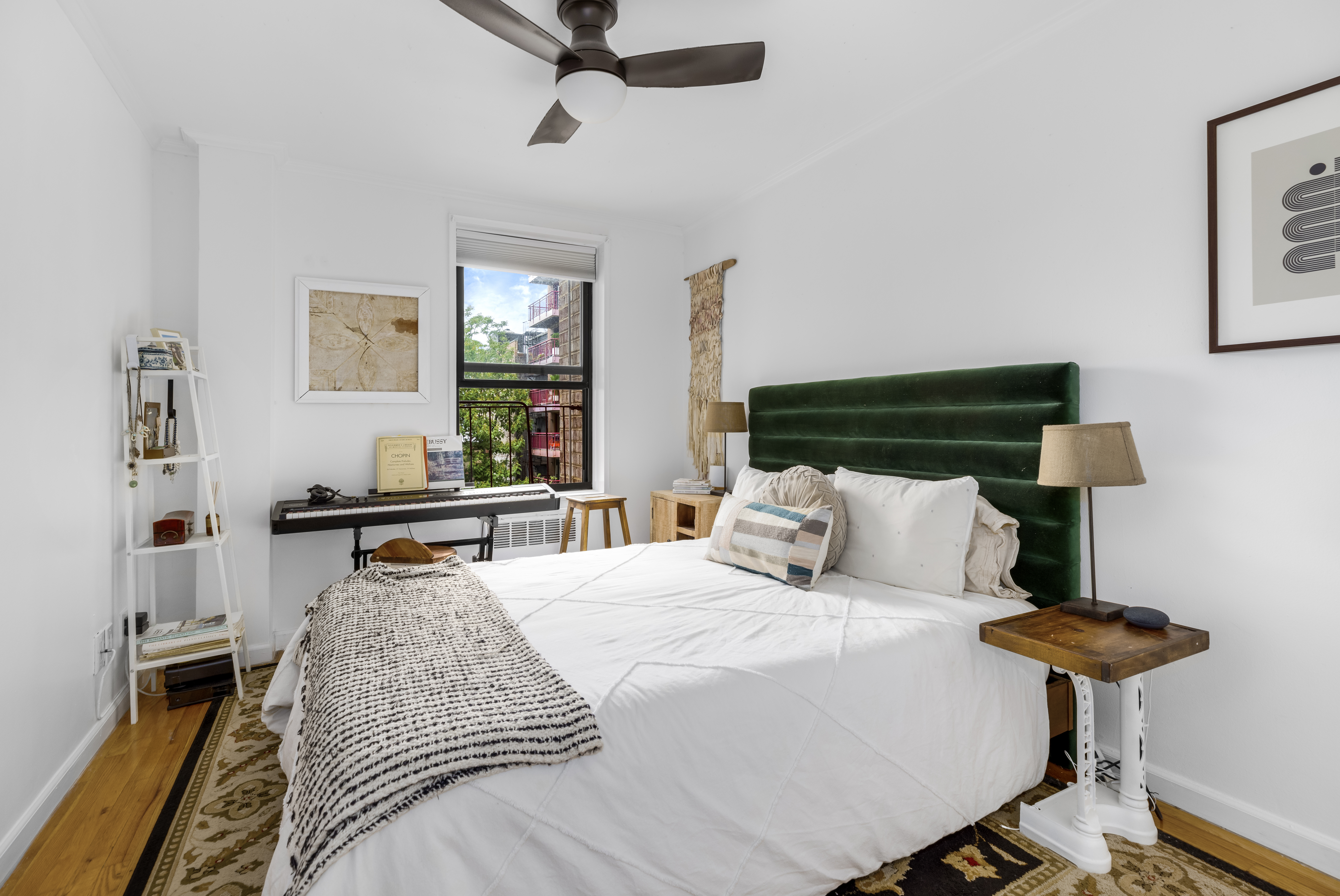 165 Christopher Street, Unit 3A Manhattan, NY 10014 - Photo 6 of 8 a bedroom with a bed and a lamp on table