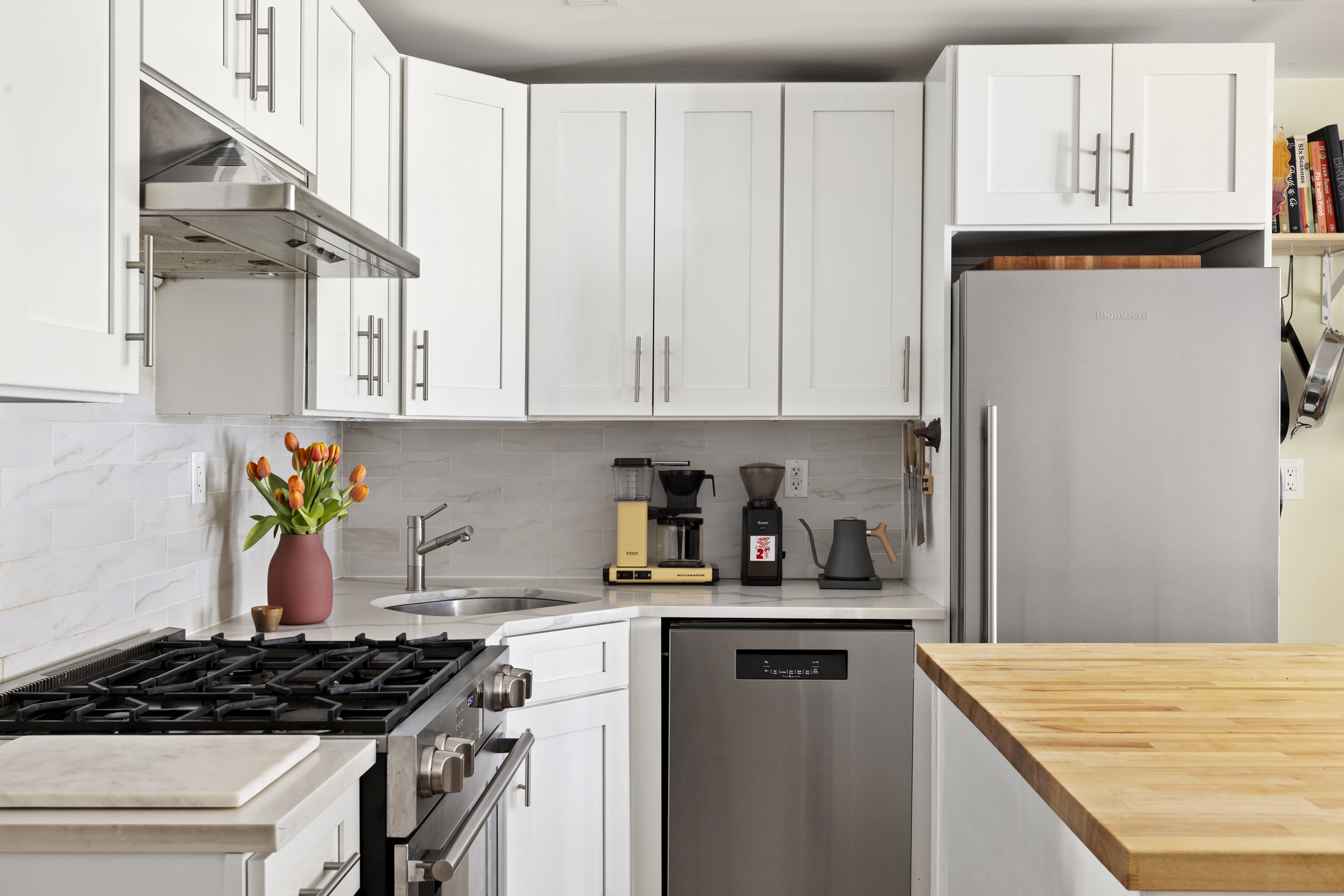 437 Putnam Avenue, Unit 1 Brooklyn, NY 11221 - Photo 7 of 12 a kitchen with white cabinets and appliances
