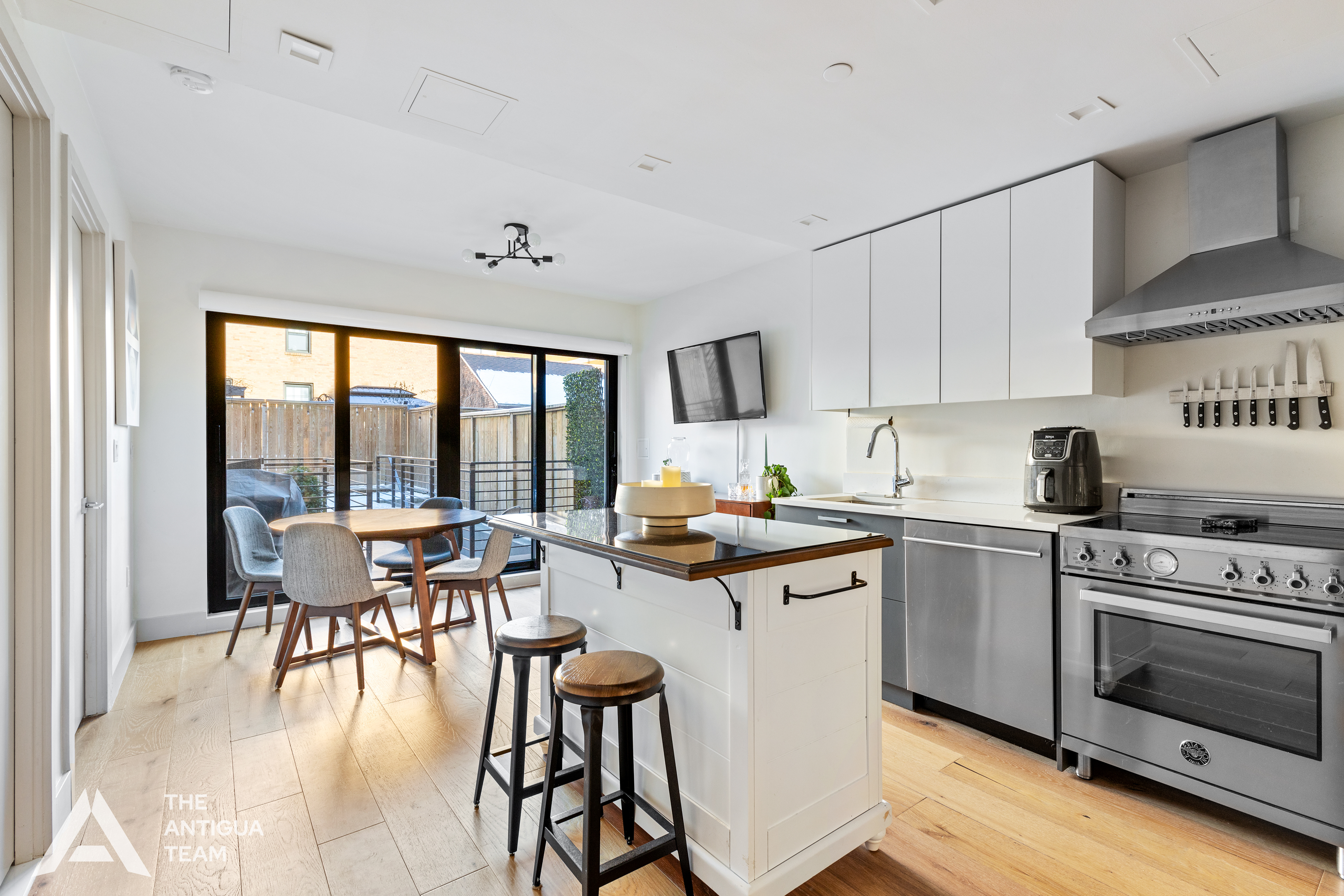 167 Eagle Street, Unit 1B Brooklyn, NY 11222 - Photo 2 of 13 a kitchen with stainless steel appliances a stove a sink dishwasher and white cabinets with wooden floor