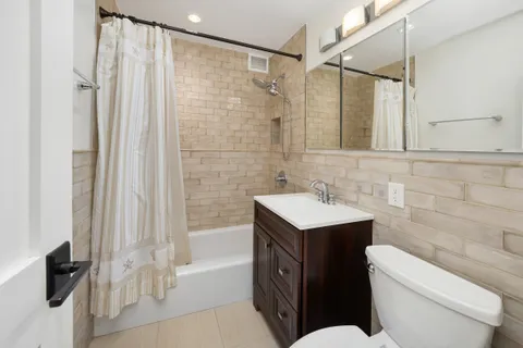 a bathroom with a sink toilet vanity and shower