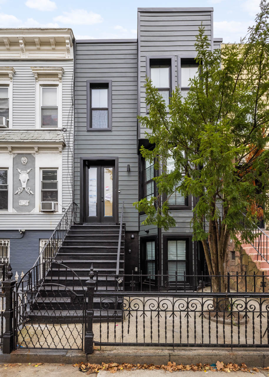668 Decatur Street Brooklyn, NY 11233 - Photo 12 of 14 a view of a house with a window and wooden fence