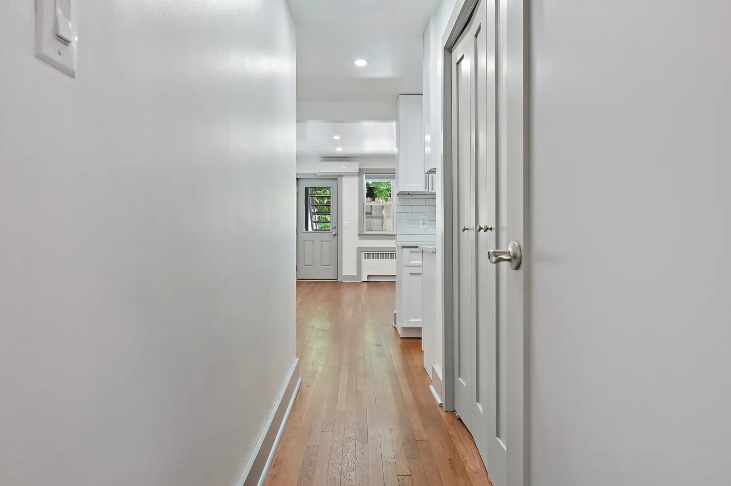 a view of a hallway with wooden floor