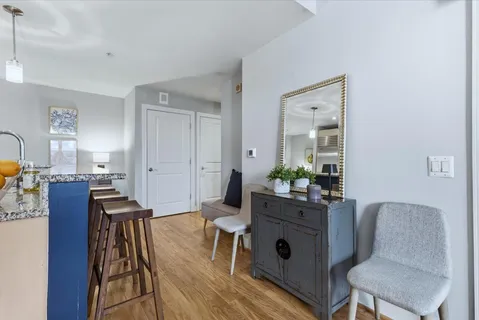 a dining room with furniture and wooden floor