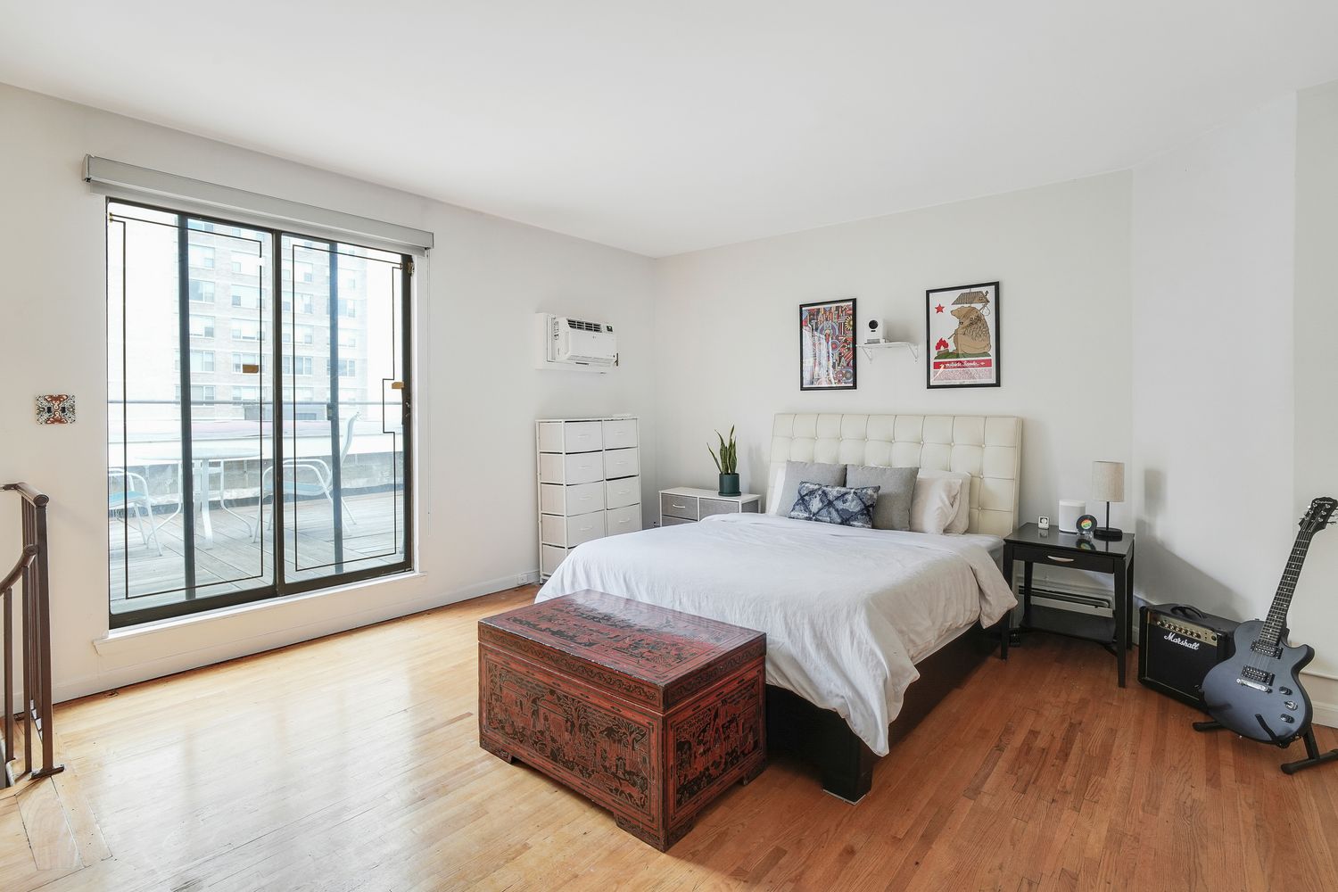 a spacious bedroom with a bed and a large window