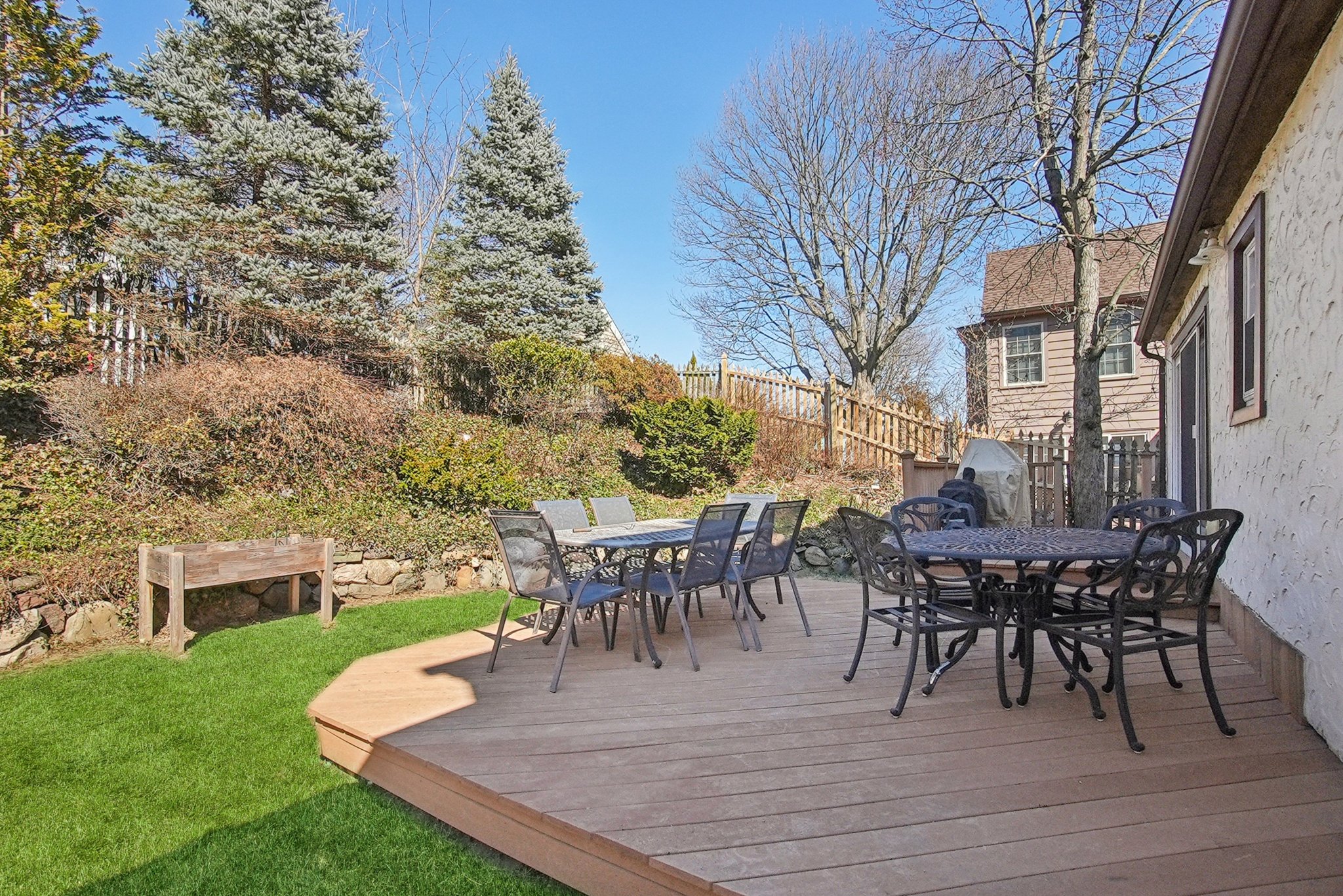 877 Ridgewood Road Millburn, NJ 07041 - Photo 29 of 37 a view of a patio with table and chairs and potted plants with wooden floor and fence