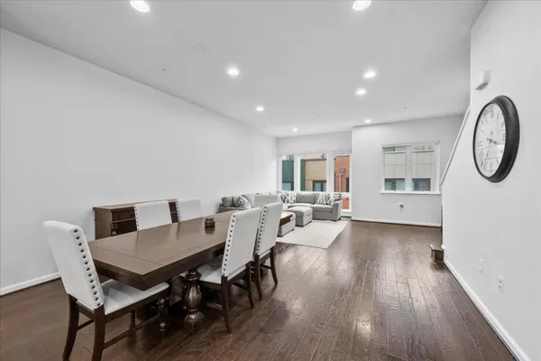 a living room with furniture a wooden floor and a large window