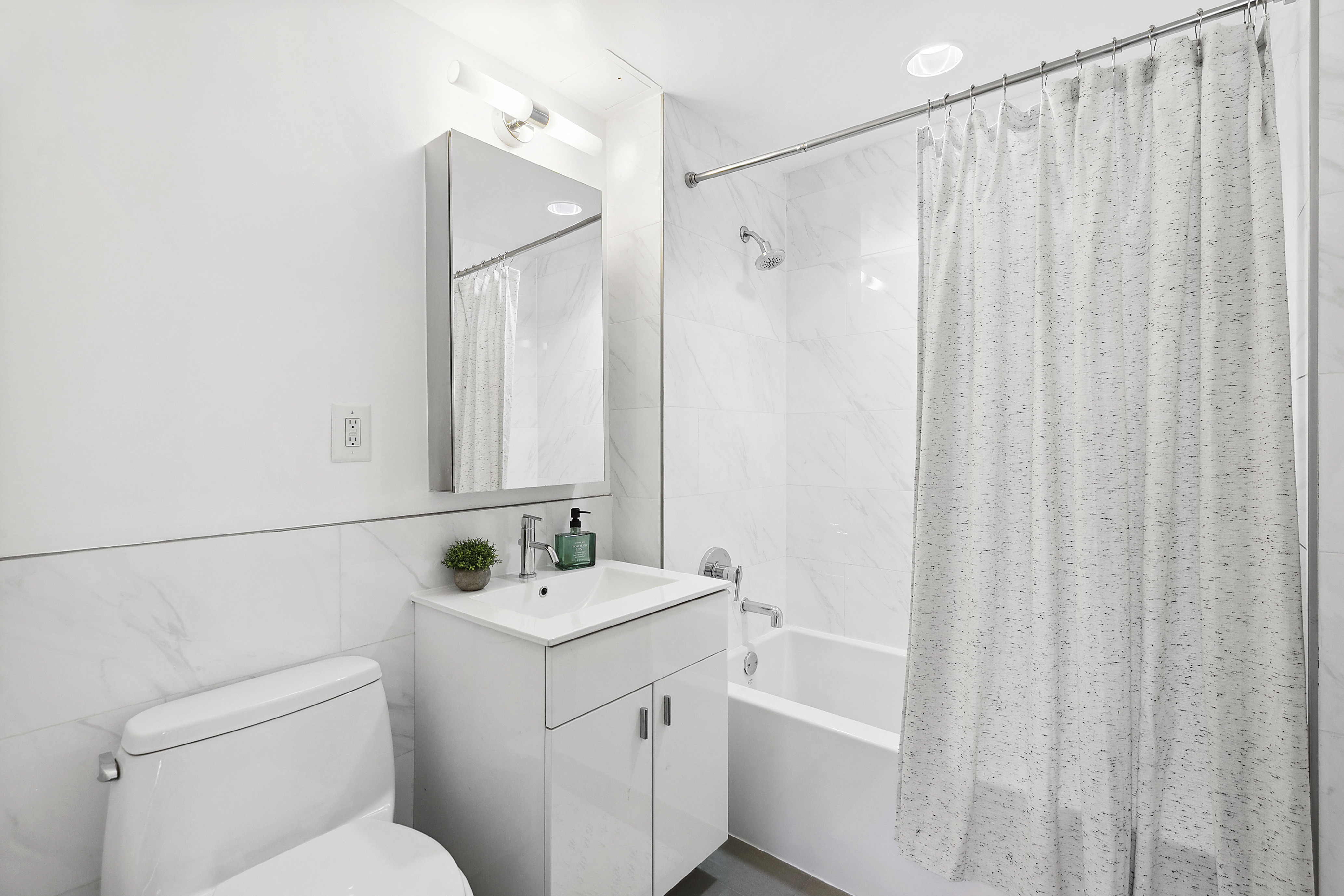 171 West 131st Street, Unit 407 Manhattan, NY 10027 - Photo 11 of 18 a bathroom with a sink a toilet and shower