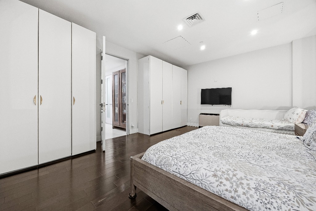 111 Fulton Street, Unit 824 Manhattan, NY 10038 - Photo 24 of 35 a large bedroom with a bed and a flat screen tv