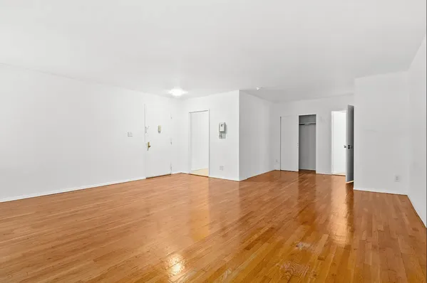 a view of an empty room and wooden floor