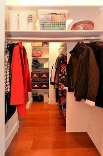a view of walk in closet with clothes and shoes
