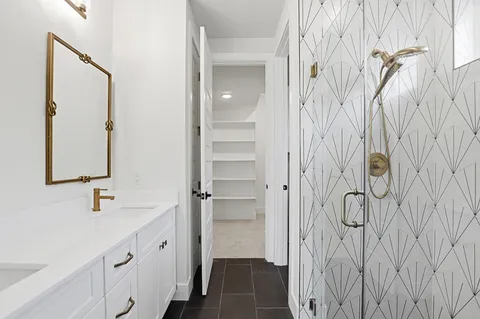 a bathroom with a shower and a sink