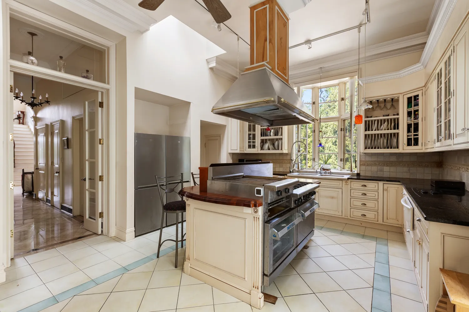 a kitchen with stainless steel appliances granite countertop a stove a sink and a refrigerator