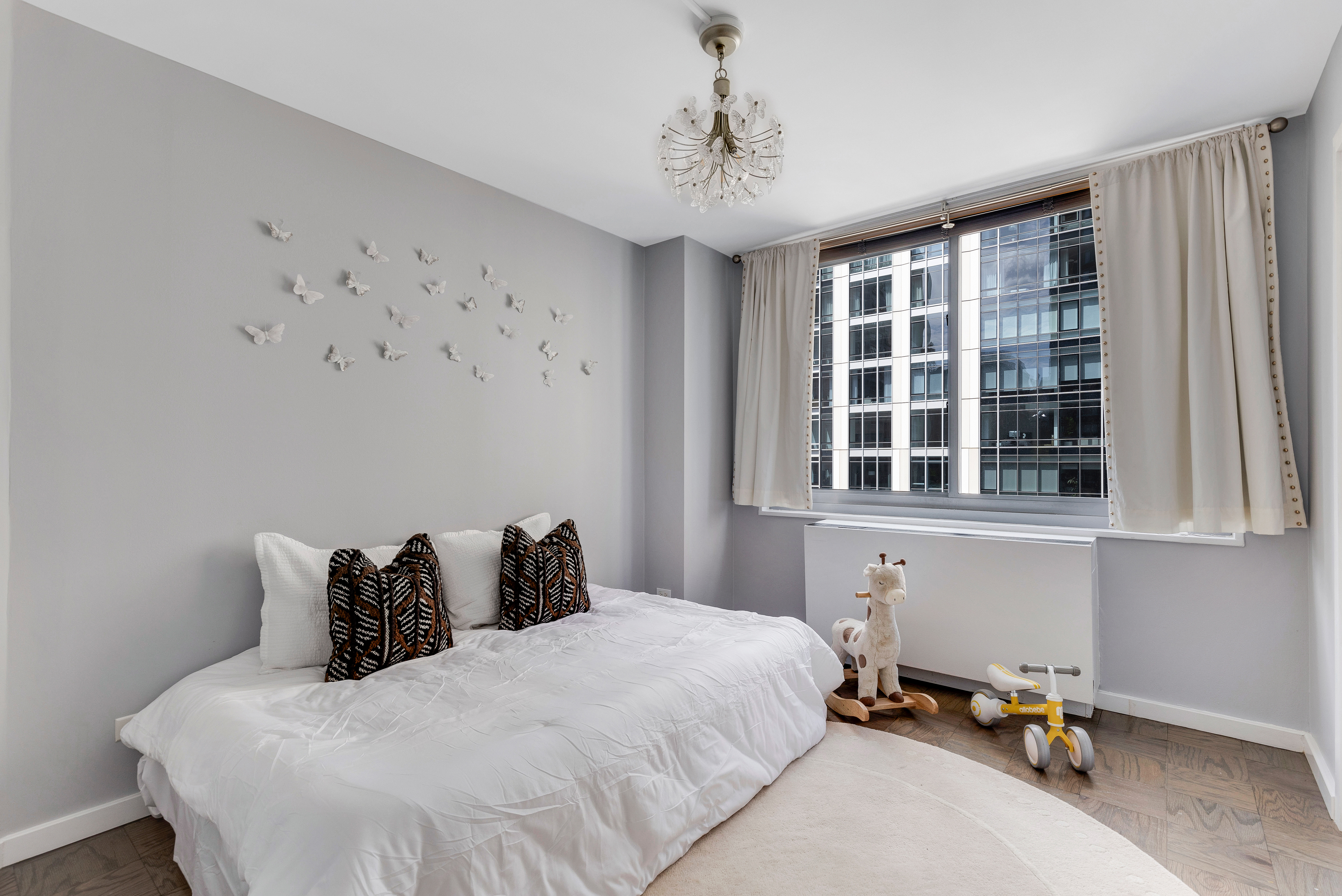 2025 Broadway, Unit 7AB Manhattan, NY 10023 - Photo 7 of 13 a bedroom with a bed and window