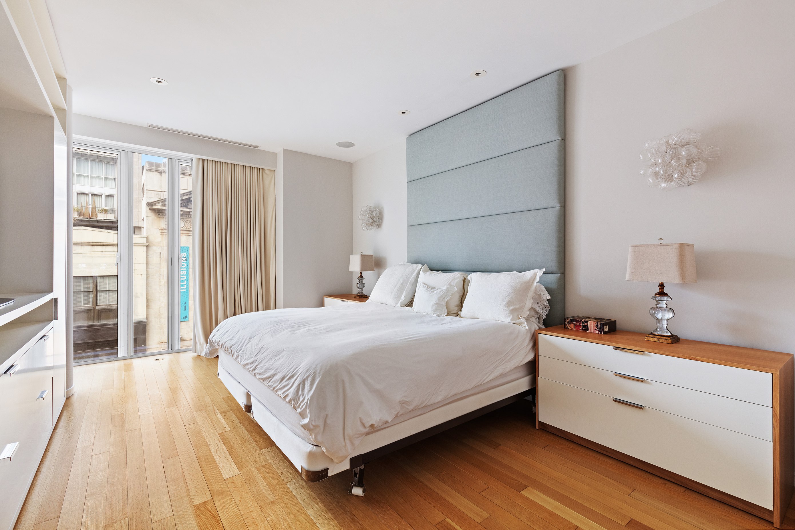 122 Greenwich Avenue, Unit 6 Manhattan, NY 10011 - Photo 5 of 13 a bedroom with a bed and a large window