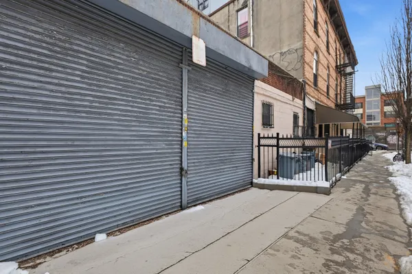a view of a building with wooden fence