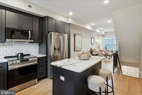 a kitchen with a sink stove and refrigerator