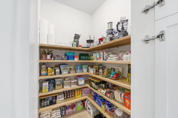 a open kitchen with stainless steel appliances kitchen island granite countertop a sink a stove and a wooden floors