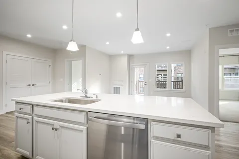 a kitchen with a sink and chandelier