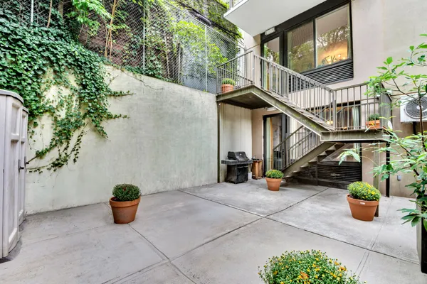 a view of a house with sitting area and potted plants