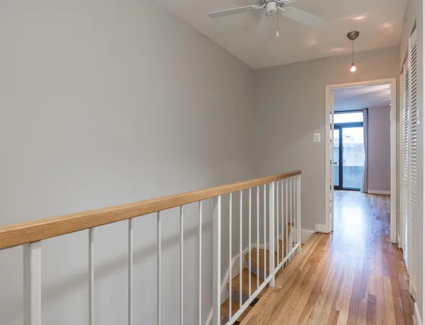 a view of a hallway with wooden floor