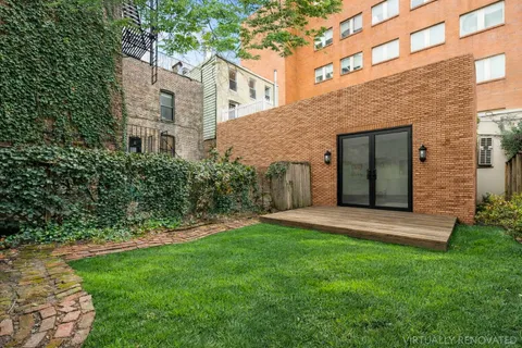 a view of an house with backyard space and garden