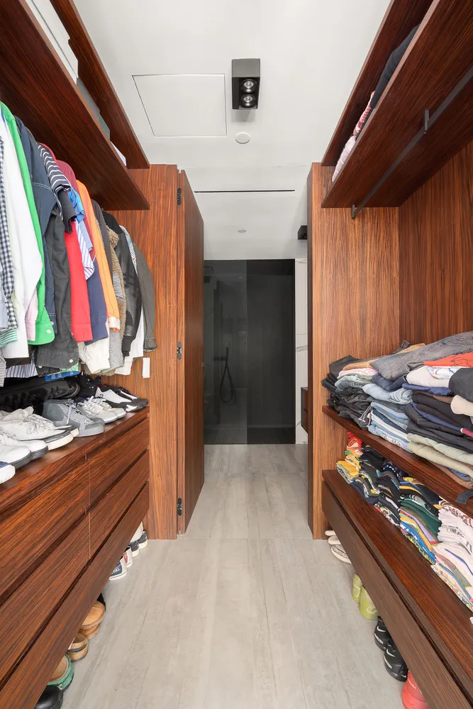 a view of walk in closet with clothes