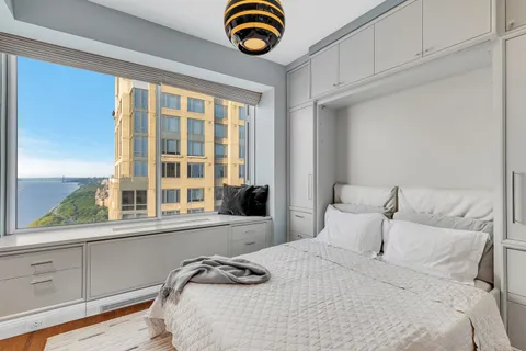 a bedroom with a bed and a window