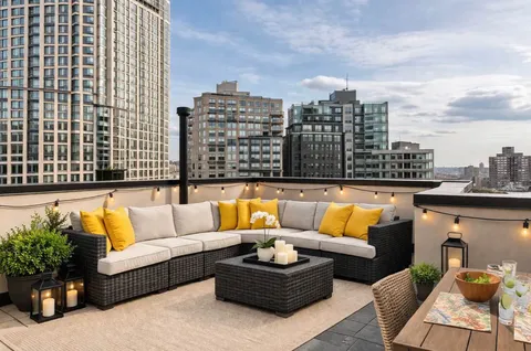 a white couch sitting in the middle of a city