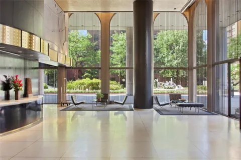 a swimming pool with outdoor seating and yard